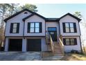 Charming two-story home with a black trim and black two car garage at 1305 Country Acres Ln, Lawrenceville, GA 30045