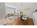 Bright living room with hardwood floors, neutral paint, modern furniture, and large windows at 7316 Wagon Wheel Ct, Jonesboro, GA 30236