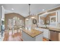 Open kitchen featuring granite counters, a large island, and hardwood floors at 994 Fairview Club Cir, Dacula, GA 30019