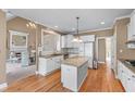 Bright kitchen featuring granite counters, stainless appliances, and hardwood floors at 994 Fairview Club Cir, Dacula, GA 30019