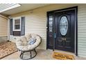 Inviting front porch with a comfortable papasan chair and a welcoming doormat at 544 Stratford Grn, Avondale Estates, GA 30002