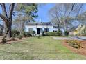 Lovely blue single-Gathering home boasting a lush front lawn and mature trees, perfect for curb appeal at 1926 N Decatur Ne Rd, Atlanta, GA 30307