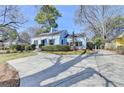 Inviting blue home with a spacious driveway and well-maintained landscaping on a sunny day at 1926 N Decatur Ne Rd, Atlanta, GA 30307