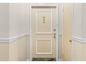 Clean interior hallway with a tan door and brass hardware at 6851 Roswell Rd # L1, Atlanta, GA 30328