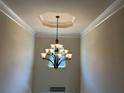 Elegant foyer features a modern chandelier and trim at 15 Blanket Pass, Covington, GA 30016