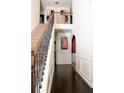 Inviting foyer with dark hardwood floors, staircase, and wainscoting detail at 15 Blanket Pass, Covington, GA 30016