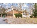 Lovely house with a spacious carport, surrounded by green shrubs and a well-kept lawn at 1729 Norden Rd, Riverdale, GA 30296