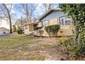 Inviting single-story home with a well-maintained lawn and mature trees at 1729 Norden Rd, Riverdale, GA 30296