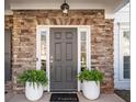 Inviting front entrance with a stylish door, surrounded by stone accents and decorative planters for a warm welcome at 3125 Crooked Stick Dr, Cumming, GA 30041