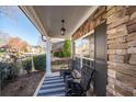 Cozy front porch showcasing seating, stone accents, and neighborhood views for relaxed outdoor living at 3125 Crooked Stick Dr, Cumming, GA 30041