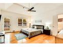 Cozy main bedroom boasts hardwood floors, a ceiling fan, and access to the bathroom and backyard at 1408 Aramore Dr, Conyers, GA 30013