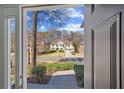 Exterior view from doorway shows home with manicured lawn, mature trees, and a two-car garage at 3752 Upland Dr, Marietta, GA 30066