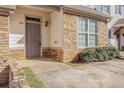 Inviting entrance with stone facade, neutral door, and manicured landscaping at 4273 High Park Ln # 15, Atlanta, GA 30344