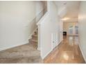 Bright hallway with hardwood floors and carpeted stairs at 4273 High Park Ln # 15, Atlanta, GA 30344