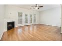 Spacious living room featuring a fireplace, hardwood floors, and French doors at 4273 High Park Ln # 15, Atlanta, GA 30344