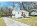 Single-story home featuring a side entrance, long driveway, and well-maintained lawn at 1096 Ferndale St, Stone Mountain, GA 30083
