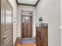 Warm entryway featuring hardwood floors, decor, and gray wainscoting at 2318 Willington Shoals Se Pl, Smyrna, GA 30080