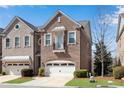 Beautiful brick townhome featuring manicured lawn and attached single car garage at 2318 Willington Shoals Se Pl, Smyrna, GA 30080
