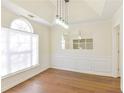 Bright dining room with wainscoting, wood floors, a modern light fixture and a large window at 3165 Bellestone Ct, Marietta, GA 30066