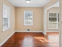 Inviting living room featuring gleaming hardwood floors, large windows, and neutral paint tones, creating a serene atmosphere at 1160 Kathryn Cir, Forest Park, GA 30297