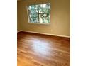 Bright bedroom featuring hardwood floors and a sunlit window at 2574 Stratford Ln, Morrow, GA 30260