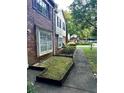 Brick home featuring a long walkway, windows, and an established garden at 2574 Stratford Ln, Morrow, GA 30260