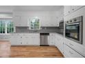 Updated kitchen features white cabinets, stainless steel appliances, and granite countertops at 4647 Wonder Valley Trl, Decatur, GA 30034