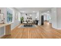 Bright living room showcasing hardwood floors, a modern sofa, and large windows providing ample natural light at 4647 Wonder Valley Trl, Decatur, GA 30034