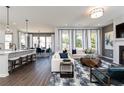 Bright open-concept living room flows into dining area with modern decor at 104 Cedar Brook Dr, Holly Springs, GA 30115