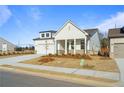 An inviting home features a two-car garage, a landscaped yard, and a well-maintained lawn at 1693 Juniper Berry Way, Loganville, GA 30052