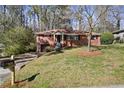 Single-story brick home featuring a well-kept lawn and inviting curb appeal at 793 Parkway Se Dr, Smyrna, GA 30080