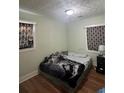 A quaint bedroom with neutral walls and hardwood flooring, featuring patterned curtains at 1032 Brian Ln, Forest Park, GA 30297