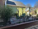 Outdoor patio area with a charming seating arrangement and decorative iron fencing at 3513 Kensington Parc Cir, Avondale Estates, GA 30002