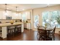 Bright kitchen features granite countertops, stainless appliances, pendant lighting, and a breakfast nook with a view at 4025 Toulon Ln, Cumming, GA 30040