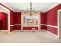 Elegant dining room with bright windows, chandelier, and classic trim work at 4484 Hunters Way, Stone Mountain, GA 30083