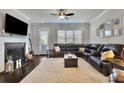 Cozy living room with fireplace, large sectional couch, neutral carpet and filled with natural light at 318 Lantana Ln, Woodstock, GA 30188