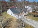 Birds-eye view of a lovely home with mature trees and landscaping shows the full property at 3412 Hard Creek Ln, Buford, GA 30519