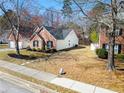 Landscaped front yard with a well maintained lawn and manicured flower beds by the sidewalk at 3412 Hard Creek Ln, Buford, GA 30519