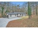 View of the house and the connected garage, showcasing the wide driveway and ample space at 1555 Sunnybrook Farm Rd, Atlanta, GA 30350