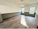 Dining room featuring modern lighting, neutral walls, and laminate flooring at 6159 Sable Fox Dr, Riverdale, GA 30296