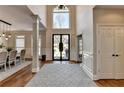 Bright foyer features soaring ceilings, decorative columns, and an elegant front door at 1046 Sterling Ridge, Marietta, GA 30062
