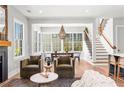 Bright, open-concept living area with large windows, hardwood floors, and a cozy fireplace at 289 2Nd St, Fayetteville, GA 30214