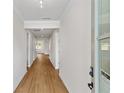 Bright hallway featuring wood flooring, leading to other areas of the home, with natural light streaming in at 1692 Juniper Berry Way, Loganville, GA 30052