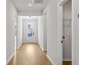 Well-lit hallway showcasing hardwood floors and access to the laundry, leading to the back door at 1692 Juniper Berry Way, Loganville, GA 30052