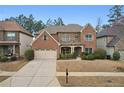 Beautiful two-story brick home featuring manicured landscaping and an attached two-car garage at 2126 Roberts View Trl, Buford, GA 30519