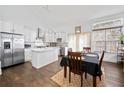 Bright kitchen with stainless steel appliances, island with marble countertop, and hardwood floors at 2826 Cobb Place Manor Ct, Marietta, GA 30066