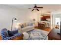 Comfortable living room with white sofa, hardwood floors, and view of the open-concept kitchen and dining area at 1175 Glenridge Pl, Atlanta, GA 30342