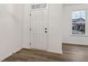 Bright entryway with white door and neutral flooring offering a clean transition into the home at 5384 Heron Bay Blvd, Locust Grove, GA 30248