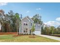 Two-story home with brick and siding, complemented by a green lawn, showcasing suburban charm at 5384 Heron Bay Blvd, Locust Grove, GA 30248