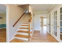 Inviting foyer with hardwood floors, staircase, and access to multiple rooms at 5385 Saffron Dr, Dunwoody, GA 30338
